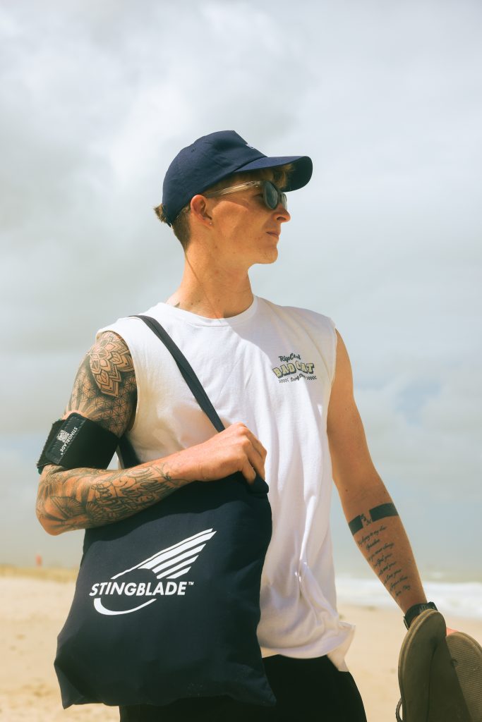 a man on a beach wearing stingblade personal sport